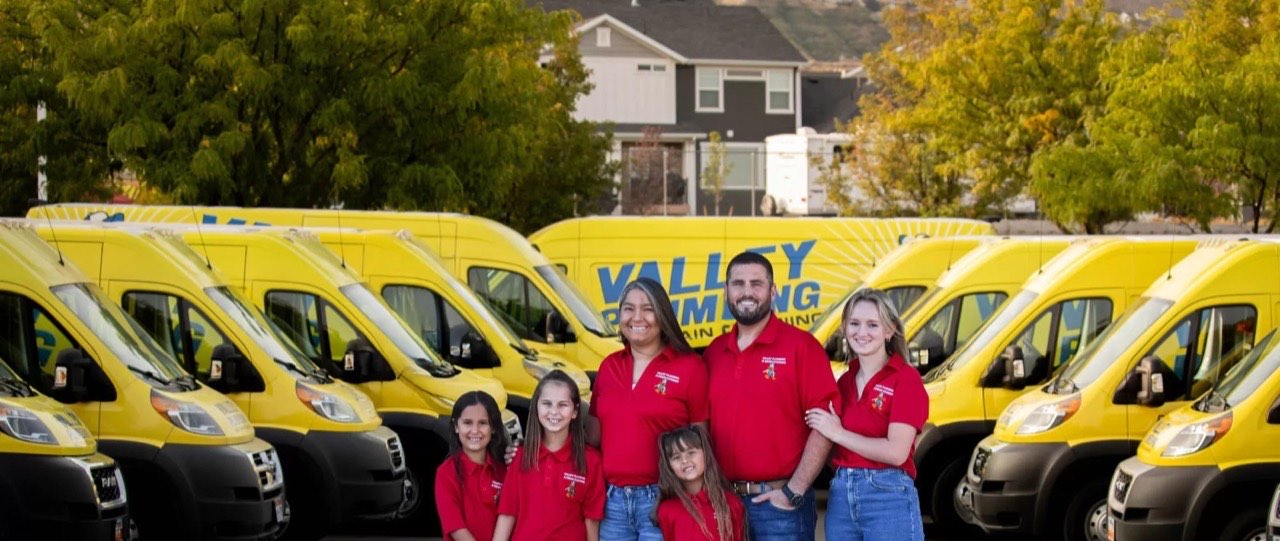 Two Valley Plumbing technicians in front of a service truck